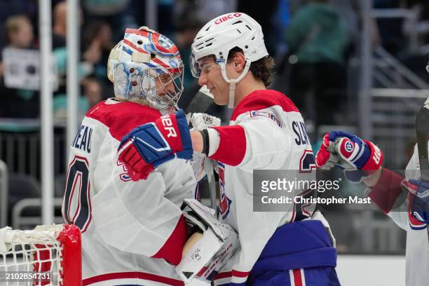 Cayden Primeau of the Montreal Canadiens is congratulated by Juraj Slafkovsky after a game against the Seattle Kraken at Climate Pledge Arena on...