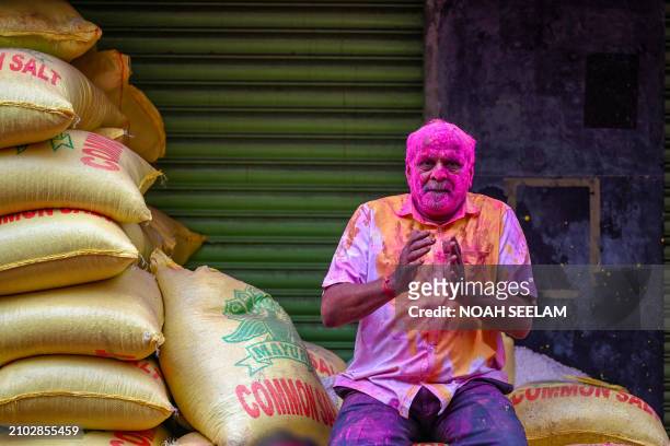 Man is smeared with 'Gulal' as he celebrates Holi, the Hindu spring festival of colours, in Hyderabad on March 25, 2024.