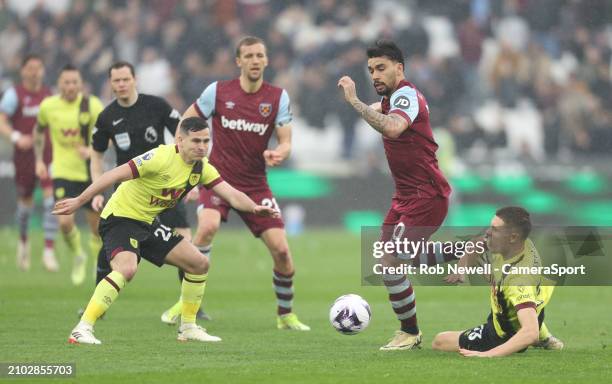 West Ham United's Lucas Paqueta gets in between Burnley's Maxime Esteve and Josh Cullen during the Premier League match between West Ham United and...