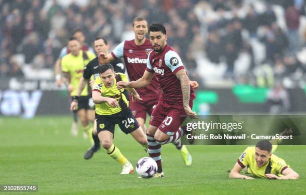 West Ham United's Lucas Paqueta gets in between Burnley's Maxime Esteve and Josh Cullen during the Premier League match between West Ham United and...