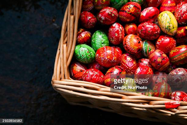 Hand-painted wooden Easter eggs are being displayed at the Easter fair on the Main Square in Krakow, Poland, on March 24, 2024. Palm Sunday, which...