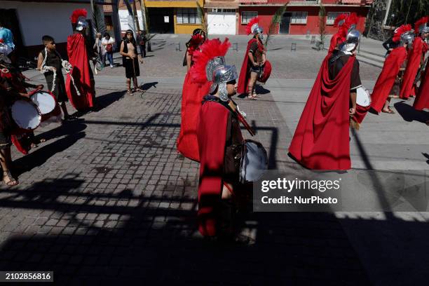 Group of young people is dressing as Romans and celebrating Palm Sunday with a procession in the streets of Culhuacan in the far south of Mexico...