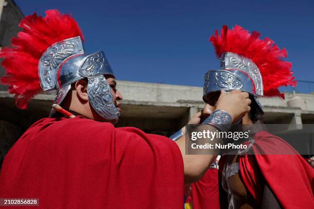 Group of young people is dressing as Romans and celebrating Palm Sunday with a procession in the streets of Culhuacan in the far south of Mexico...