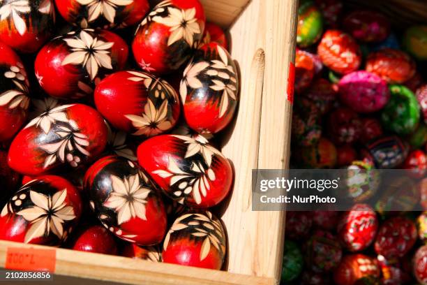 Hand-painted wooden Easter eggs are being displayed at the Easter fair on the Main Square in Krakow, Poland, on March 24, 2024. Palm Sunday, which...