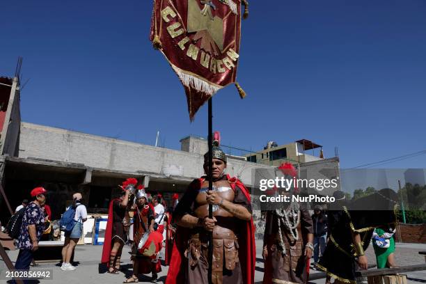 Group of young people is dressing as Romans and celebrating Palm Sunday with a procession in the streets of Culhuacan in the far south of Mexico...