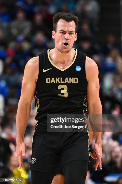 Jack Gohlke of the Oakland Golden Grizzlies celebrates after making a three pointer against the Kentucky Wildcats during the second half in the first...