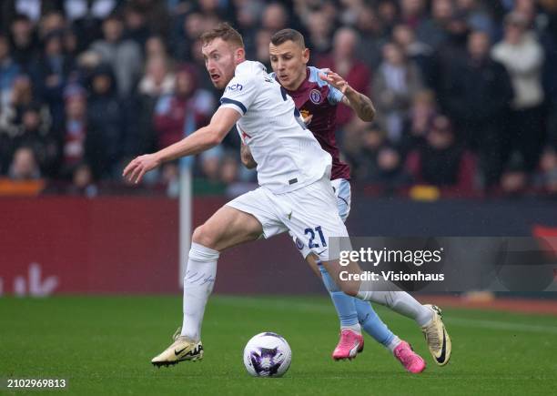 Dejan Kulusevski of Tottenham Hotspur is challenged by Lucas Digne of Aston Villa during the Premier League match between Aston Villa and Tottenham...