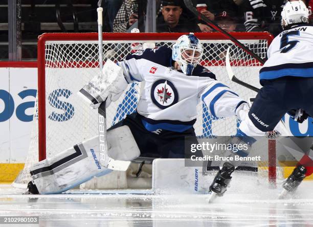 Laurent Brossoit of the Winnipeg Jets makes the third period save against the New Jersey Devils at Prudential Center on March 21, 2024 in Newark, New...