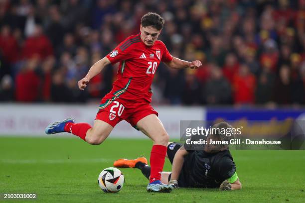 Daniel James of Wales rounds Lukas Hradecky of Finland to score his side's fourth goal during the UEFA EURO 2024 Play-Offs Semi-final match between...