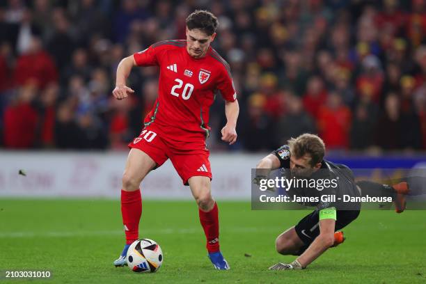 Daniel James of Wales rounds Lukas Hradecky of Finland to score his side's fourth goal during the UEFA EURO 2024 Play-Offs Semi-final match between...