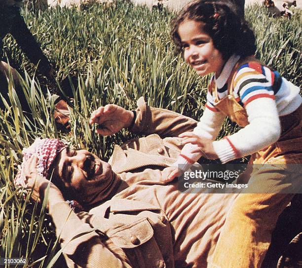 In this undated photo, Saddam Hussein plays with his daughter, Hala.