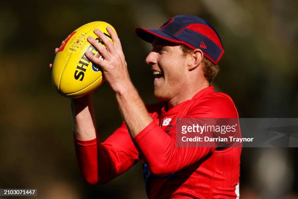 Harrison Petty of the Demons marks the ball during a Melbourne Demons AFL training session at Gosch's Paddock on March 22, 2024 in Melbourne,...