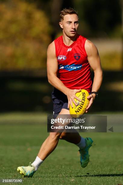 Bailey Laurie of the Demons runs with the ball during a Melbourne Demons AFL training session at Gosch's Paddock on March 22, 2024 in Melbourne,...