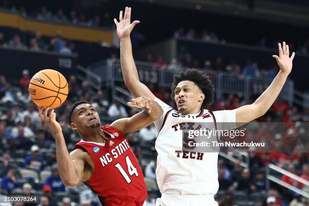 Casey Morsell of the North Carolina State Wolfpack shoots against Darrion Williams of the Texas Tech Red Raiders during the first half in the first...