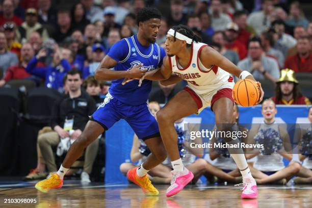 Isaac Jones of the Washington State Cougars drives to the basket against Kevin Overton of the Drake Bulldogs during the first half in the first round...