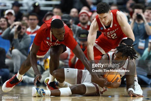 Joe Toussaint of the Texas Tech Red Raiders attempts to control the ball against Mohamed Diarra of the North Carolina State Wolfpack and Michael...