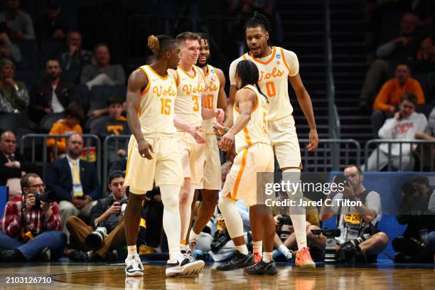 Zakai Zeigler and Dalton Knecht of the Tennessee Volunteers react during the second half against the Saint Peter's Peacocks in the first round of the...