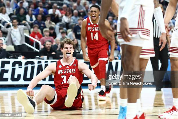 Ben Middlebrooks of the North Carolina State Wolfpack reacts with his teammate Casey Morsell during the first half of a game against the Texas Tech...