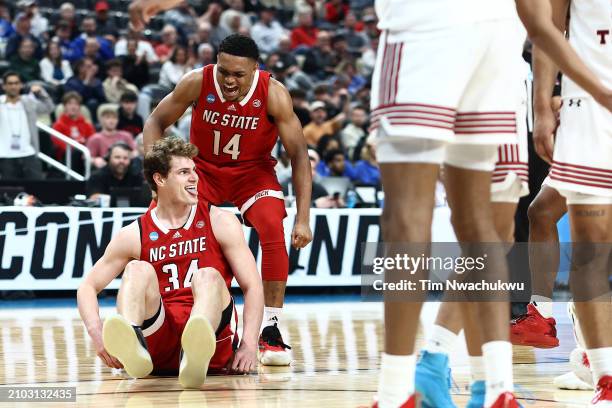 Ben Middlebrooks of the North Carolina State Wolfpack reacts with his teammate Casey Morsell during the first half of a game against the Texas Tech...