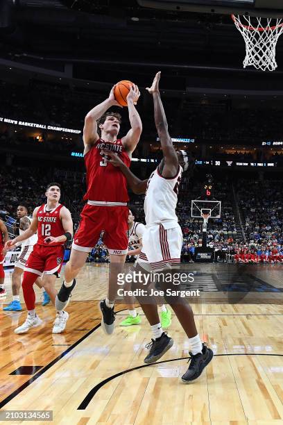 Ben Middlebrooks of the North Carolina State Wolfpack shoots against Robert Jennings of the Texas Tech Red Raiders during the first half in the first...