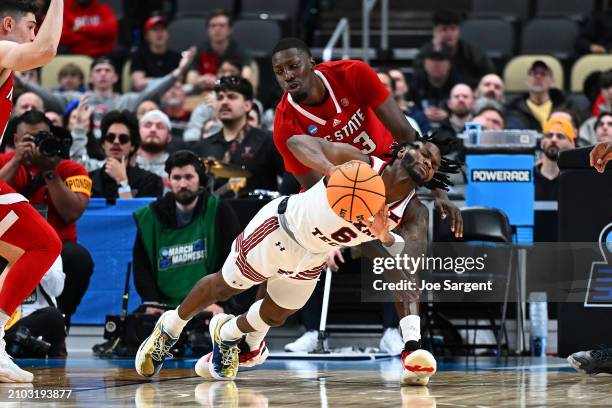 Joe Toussaint of the Texas Tech Red Raiders looks to pass against Mohamed Diarra of the North Carolina State Wolfpack during the second half in the...