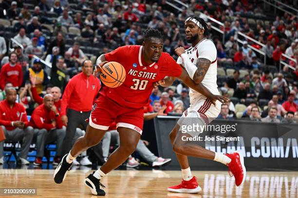 Burns Jr. #30 of the North Carolina State Wolfpack drives against Warren Washington of the Texas Tech Red Raiders during the second half in the first...
