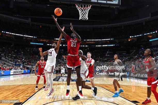 Mohamed Diarra of the North Carolina State Wolfpack and Kerwin Walton of the Texas Tech Red Raiders go up for the rebound during the second half in...