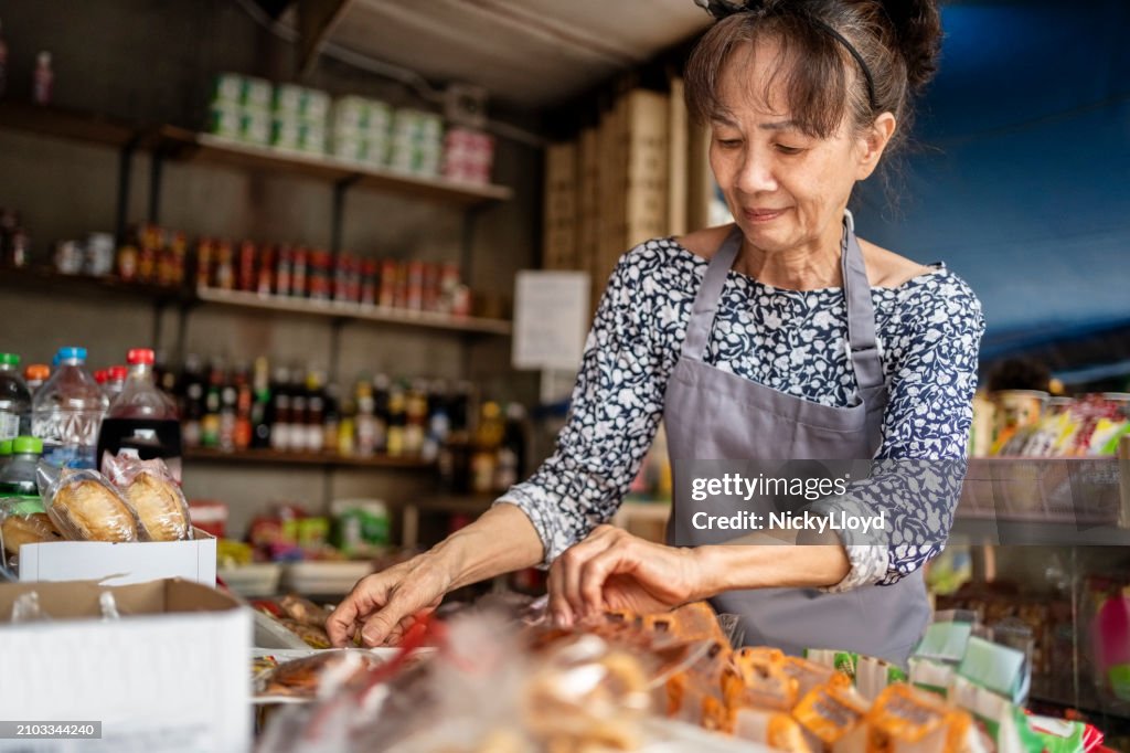 Active senior saleswoman working at a local grocery shop