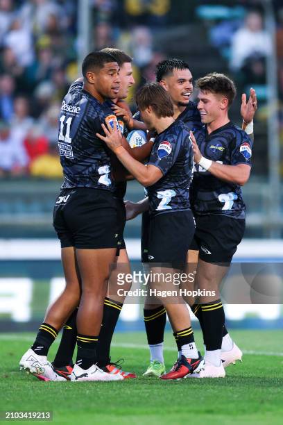 Jordie Barrett of the Hurricanes celebrates with teammates after scoring a try during the round five Super Rugby Pacific match between Hurricanes and...