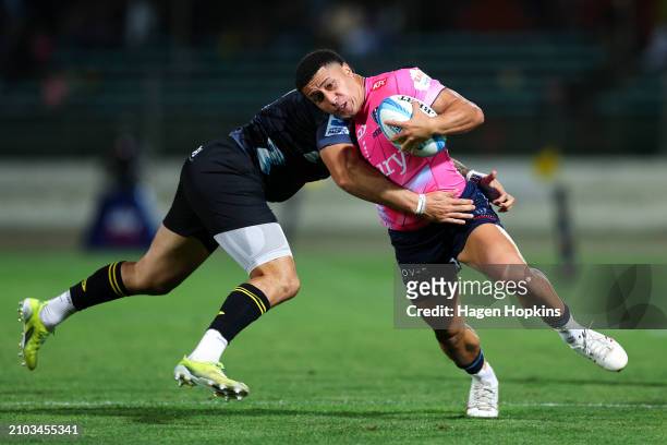 Glen Vaihu of the Rebels is tackled during the round five Super Rugby Pacific match between Hurricanes and Melbourne Rebels at Central Energy Trust...