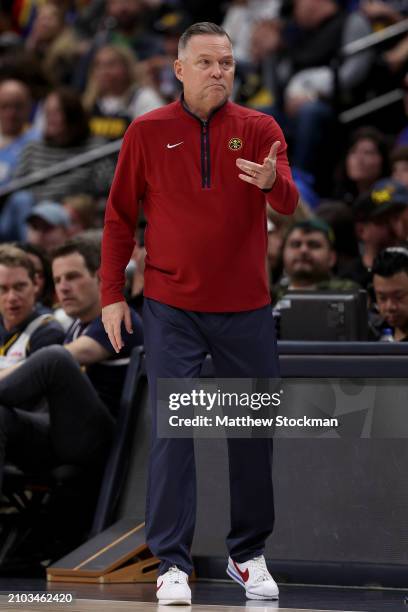 Head coach Michael Malone of the Denver Nuggets walks the sidelines while playing against the New York Knicks during the third quarter at Ball Arena...