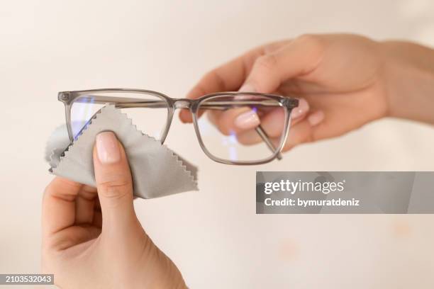 cleaning glasses with microfiber cloth - monocle stock pictures, royalty-free photos & images