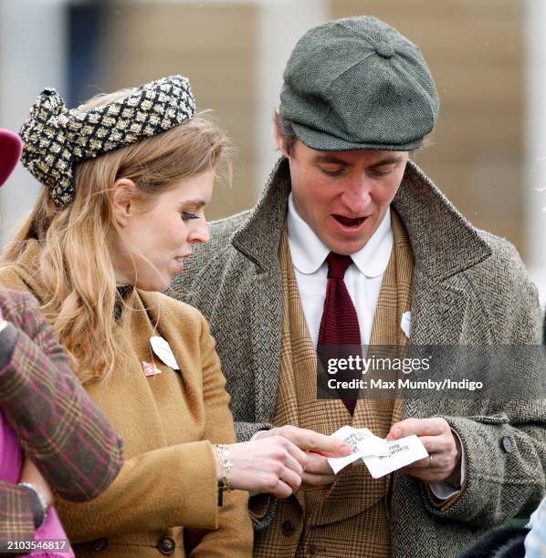 Princess Beatrice looks on as Edoardo Mapelli Mozzi checks his betting slips on day 3 'St Patrick's Thursday' of the Cheltenham Festival at...