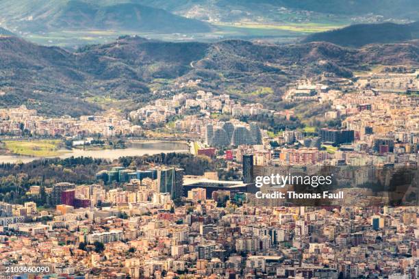 view across tirana city centre with mountains beyond - tirana stock pictures, royalty-free photos & images