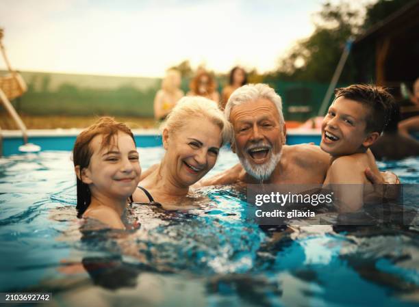 family enjoying a vacation. - senior swimming stock pictures, royalty-free photos & images