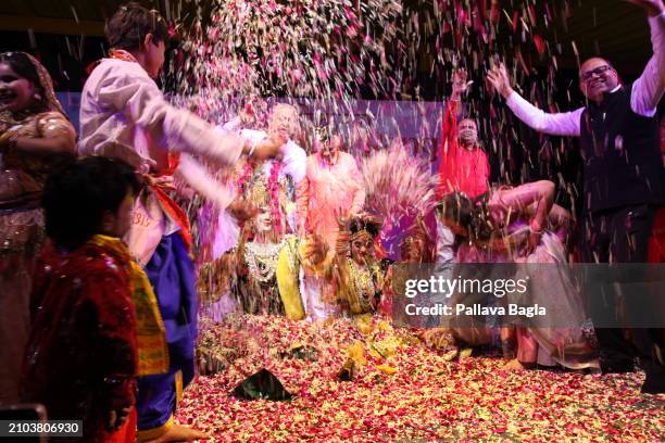 People celebrate the Hindu festival of colours, Holi, with a unique display with flowers and petals at a public show at the Indian government owned...