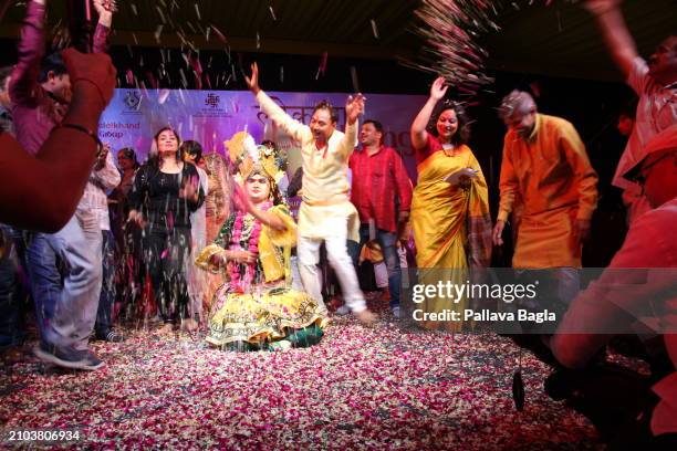 People celebrate the Hindu festival of colours, Holi, with a unique display with flowers and petals at a public show at the Indian government owned...