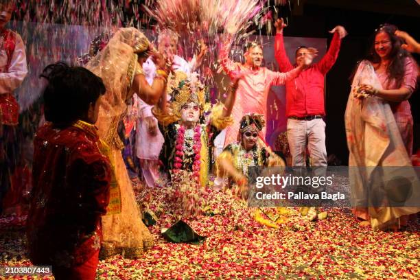 People celebrate the Hindu festival of colours, Holi, with a unique display with flowers and petals at a public show at the Indian government owned...