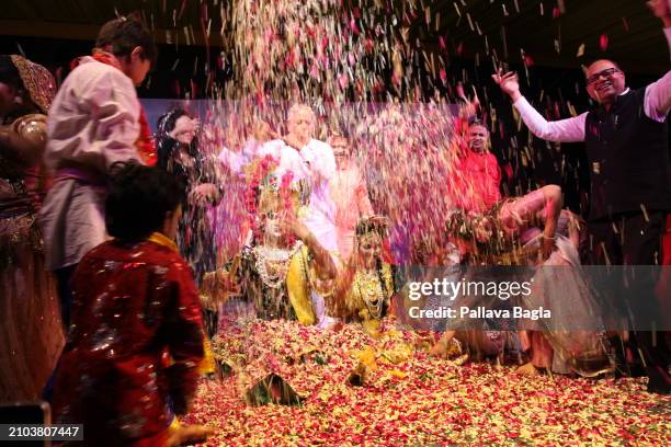 People celebrate the Hindu festival of colours, Holi, with a unique display with flowers and petals at a public show at the Indian government owned...