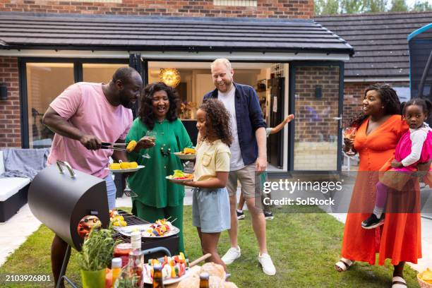 queuing up for bbq food - hot mom stock pictures, royalty-free photos & images