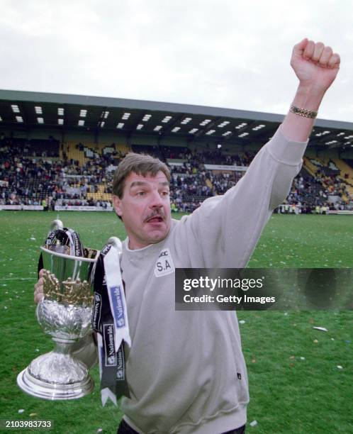 Notts County Manager Sam Allardyce celebrates with the trophy on the pitch after County had won the Nationwide League Division 3 title after a 5-2...