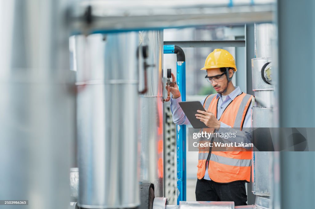 Industrial Engineer Adjusting Machinery Valve