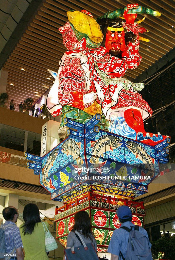 Visitors watch a 20-metre-tall lantern d