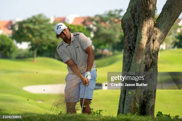 Gavin Green of Malaysia pitches out of the rough on hole 14 during Day Two of the Porsche Singapore Classic at Laguna National Golf Resort Club on...