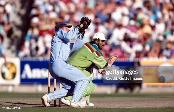 England wicketkeeper Alec Stewart looks on as Pakistan batsman Javed Miandad cuts for some runs during the 1992 World Cup Final between England and...