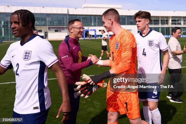 Head coach Tom Curtis of England U18 shakes hands with Finlay Herrick after the International Friendly match between England U18 and Germany U18 at...