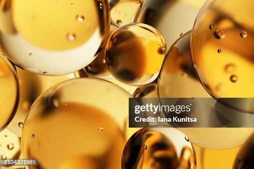 Transparent yellow oil drops, bubbles, molecules. Close-up. 3D pattern. Healthcare and medicine. Cosmetic products for skin care. Citrus. Vitamin C. Transparent yellow oil drops, bubbles, molecules. Close-up. 3D pattern. Healthcare and medicine. Cosmetic products for skin care. Citrus. Vitamin C.