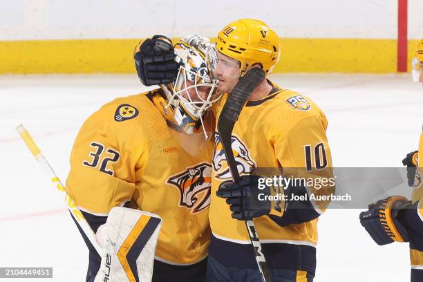 Colton Sissons congratulates goaltender Kevin Lankinen of the Nashville Predators after the 3-0 win against the Florida Panthers at the Amerant Bank...