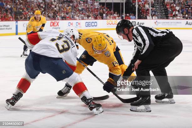 Linesman Jonathan Deschamps drops the puck between Gustav Nyquist of the Nashville Predators and Sam Reinhart of the Florida Panthers at the Amerant...