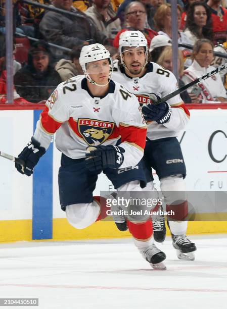 Gustav Forsling and Ryan Lomberg of the Florida Panthers skate up ice against the Nashville Predators at the Amerant Bank Arena on March 21, 2024 in...
